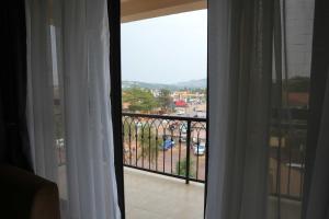 a room with a balcony with a view of a street at ENN Business Hotel in Kampala +16 photos