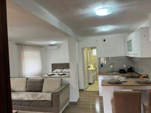 a living room and kitchen with a couch and a table at Apartment Stari Konak in Virpazar