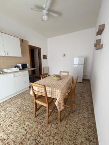 a kitchen with a table and chairs in a room at Stefano's house in Siracusa