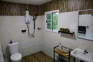 a bathroom with a toilet and a sink at Tiny Boutique House Koh Kood in Ban Lak Uan