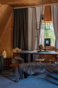 a dining room with a table and a window at Leśna Sielanka domek z jacuzzi w lesie pod Górą Szczebel RELAX I SPORT in Lubień