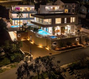 an aerial view of a house at night at Villa W by Villas & SPA Dubrovnik in Mokošica +65 photos