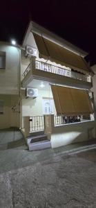 a building with balconies on the side of it at night at Giannis's Apartments in Chios +14 photos