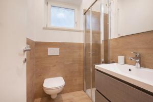 a bathroom with a toilet and a sink and a shower at Villa Cesarina-Vista lago totale in Brenzone sul Garda +10 photos