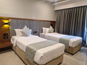 The Qubice Hotel, Kolhapur客房内的一张或多张床位