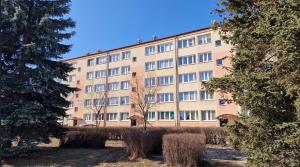 a large building with trees in front of it at Apartament przy basenie in Katowice