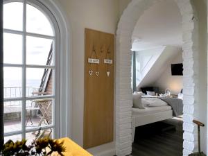 a bedroom with a bed and a large window at Huus Lüttenblick Whg Amrumblick in Südstrand