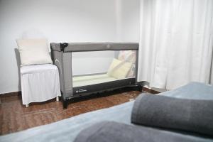 a bed and a chair sitting next to a window at Didis Place Nafplio in Nafplio