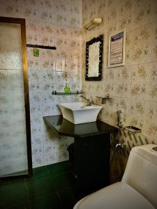 a bathroom with a sink and a toilet at 1BHK Apartment at Honeydew 8 by Goaround Homes in Vagator +18 photos