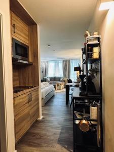 a living room with a kitchen and a living room with a couch at Apartment Schlierseeperle in Schliersee