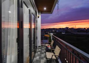 a balcony with a view of a sunset at Teen Hillside Đà Lạt- View Nhà Lồng lãng mạn in Da Lat +71 photos