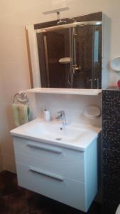 a bathroom with a white sink and a mirror at Apartment Lala in Kaštela