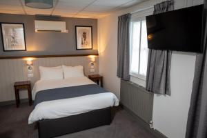 a hotel room with a bed and a television at Cocked Hat by Greene King Inns in Coventry