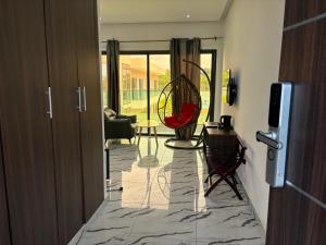 a view of a living room with a table and chairs at Madigane Residence Assinie in Assinie