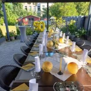 a long table with chairs and white candles on it at Hotel Restaurant Harrier Hof in Brake +5 photos