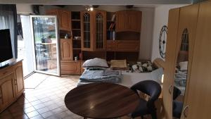 a kitchen with a wooden table and a dining room at Haus mit Terrasse&Garten in Ilsede