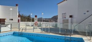 a swimming pool on the roof of a building at Los Cristianos Aqua Viva in Los Cristianos