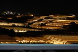 a view of a large building with lights at night at Teen Hillside Đà Lạt- View Nhà Lồng lãng mạn in Da Lat