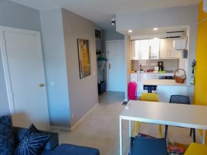 a kitchen and living room with a table and chairs at Calella Flats & More in Calella