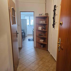 a hallway with a room with a door and a shelf at Rynek-Centrum in Olsztynek +4 photos