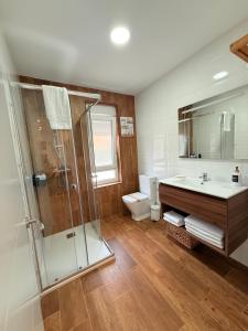 a bathroom with a shower and a sink and a toilet at La casuca de Candela in Santillana del Mar +81 photos
