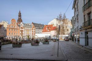 an empty city street with buildings in the background at Heart of Riga Old Town - Walk to Everything! in Rīga
