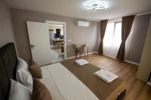 a bedroom with a bed with two towels on it at Luxury Life Suites in Istanbul