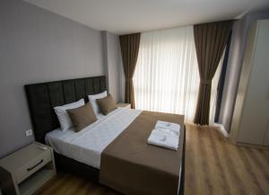 a bedroom with a large bed with a large window at Luxury Life Suites in Istanbul