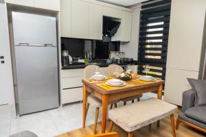 a kitchen and dining room with a wooden table and chairs at Luxury Life Suites in Istanbul
