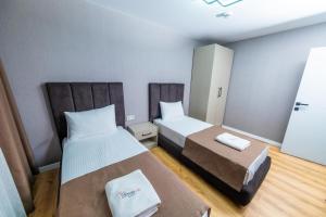 a small room with two beds and a small table at Luxury Life Suites in Istanbul
