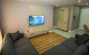 a living room with a couch and a flat screen tv at Luxury Life Suites in Istanbul