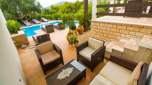 an overhead view of a patio with chairs and a pool at Villa Nia with private pool in Trogir
