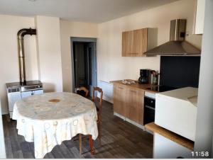 a kitchen with a small table in a kitchen at Maison 6 couchages in Bellevesvre