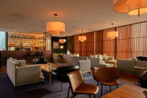 a restaurant with tables and chairs and a bar at Radisson Blu Iveria Hotel in Tbilisi City