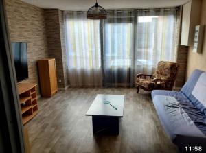 a living room with a couch and a coffee table at Maison 6 couchages in Bellevesvre