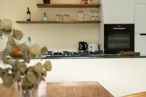 a kitchen with a counter with a stove top oven at Villa Aura Lombok in Selong Belanak