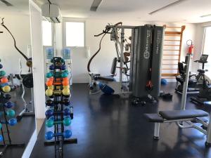 a gym with a bunch of equipment in a room at Beach Living, Frente mar, Vizinho B Park - Oficial in Mangabeira