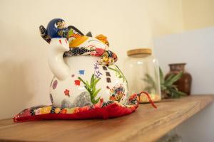 a vase sitting on top of a wooden shelf at Villa Aura Lombok in Selong Belanak