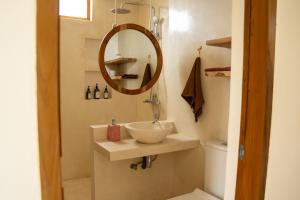 a bathroom with a sink and a mirror at Villa Aura Lombok in Selong Belanak