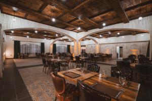 a restaurant with tables and chairs in a room at Raymar Hotels Mardin in Mardin