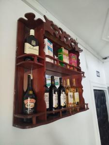 a shelf with bottles of alcohol on a wall at Hôtel Famigni in Douala