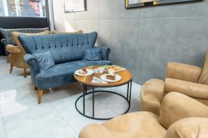 a room with a blue couch and a table with food on it at Luxury Life Suites in Istanbul