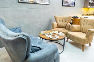 a living room with chairs and a coffee table at Luxury Life Suites in Istanbul