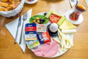 a plate of food on a table with meat and cheese at Luxury Life Suites in Istanbul