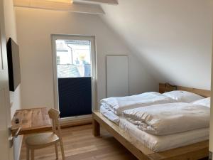 a bedroom with a bed and a desk and a window at Hof Hallenberg in Hallenberg