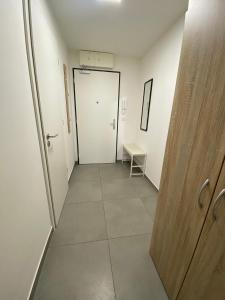 a hallway with a door and a tiled floor at NEW apartment in Prague in Prague
