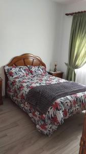 sypialnia z łóżkiem z kołdrą kwiatową w obiekcie Vivienda Vacacional Florentina w mieście Fuencaliente de la Palma