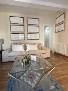 a living room with a couch and a glass table at Apartamento Neptuno A4 in Puebla de Farnals +22 photos