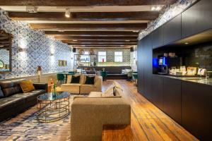 a living room with a couch and a table at Dikker & Thijs Hotel in Amsterdam