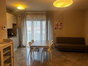 a living room with a table and chairs and a couch at "Casa Viola" via Camillo CARLOMAGNO 26 in Isernia